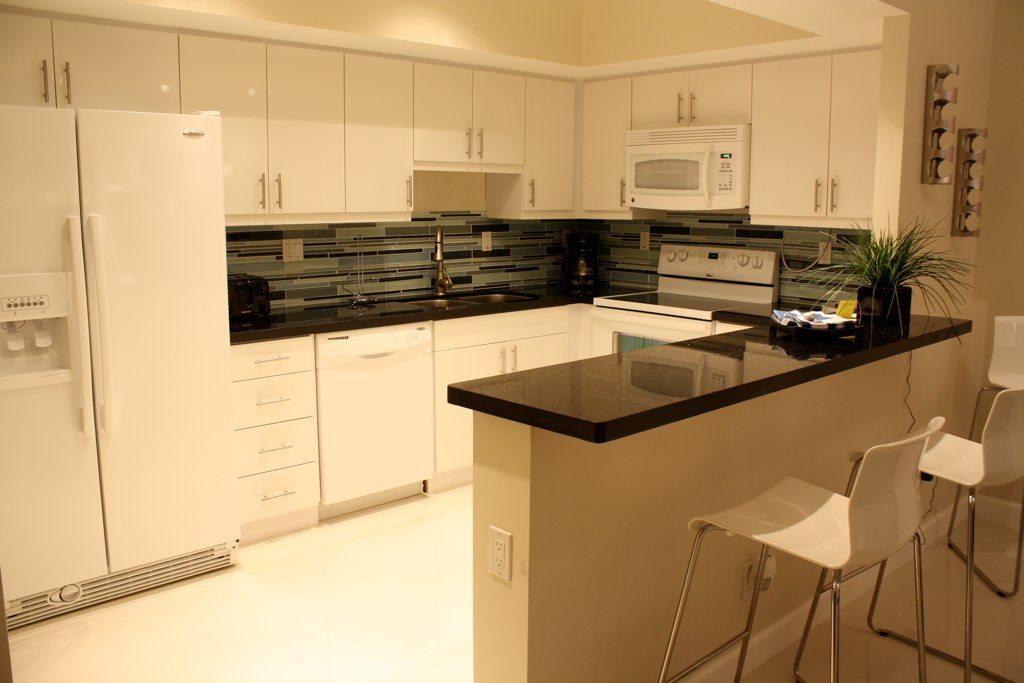 Kitchen renovation Miami Beach – white cabinets with black granite countertop